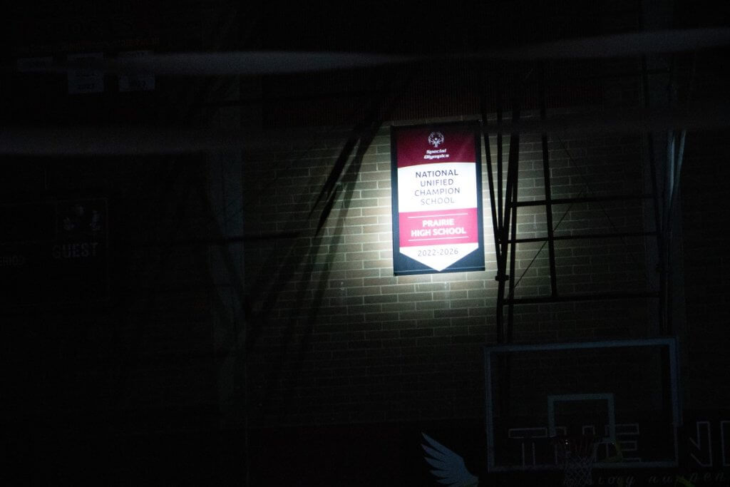 Unified Champion School banner under a spotlight